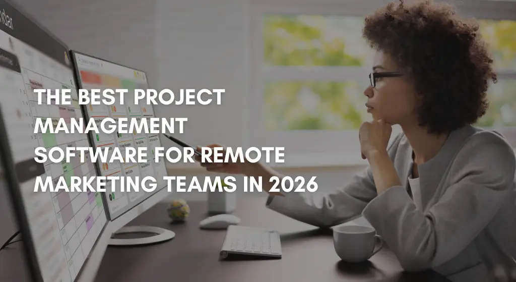 Marketing professional using project management software on dual monitors.